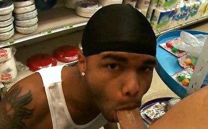 Black thug blowing cock in a public place