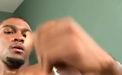 Black guy plays with his dick