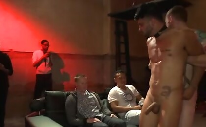 Bound hunk with an uncut cock gets gangfucked by a crowd of horny men