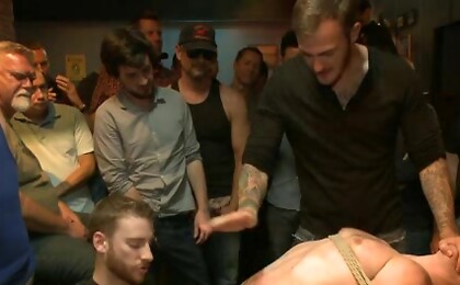Ripped stud with a giant cock get used in a crowded bar