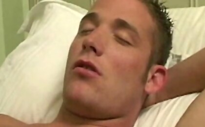 Tanned college boy gets a handjob and shoots a nice load.