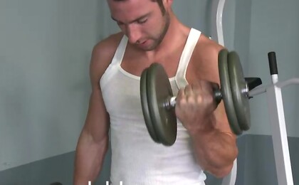 At six foot one and one hundred and seventy pounds Hayden Clark shows off his chiseled abs and firm pecs in the gym. 