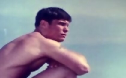Beautiful vintage boy wanders the beach in the nude