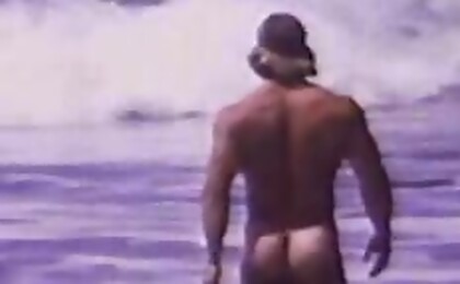 At the beach, an exhibitionist is showing his sexy curves