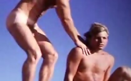Sexy gays are having fun naked in the ocean on a hot day