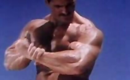 Sexy beefy gay man shows his athletic muscles to the camera